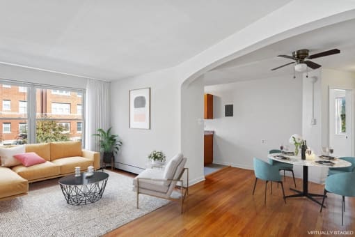 a living room with a couch and a table and a window