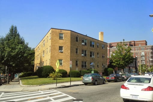 an apartment building on the corner of a street