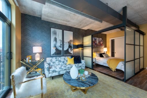 A modern living room with a grey couch and a yellow throw pillow at Coda on H Apartments, Washington, 20002