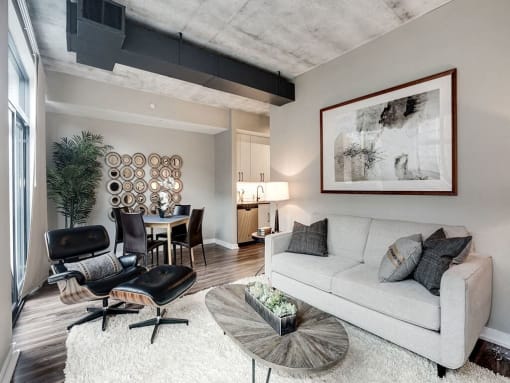 a living room with a couch and a chair and a table at Coda on H Apartments, Washington, District of Columbia