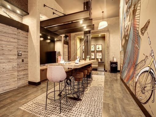 a bar with stools and a table in a lobby at Coda on H Apartments, Washington