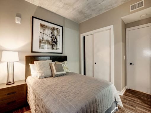 a bedroom with a bed and a picture on the wall at Coda on H Apartments, Washington, 20002
