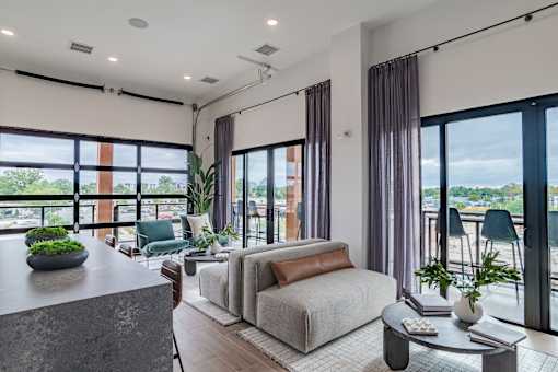 Open concept living area with floor to ceiling windows at The Yancey Apartments, North Carolina, 28217