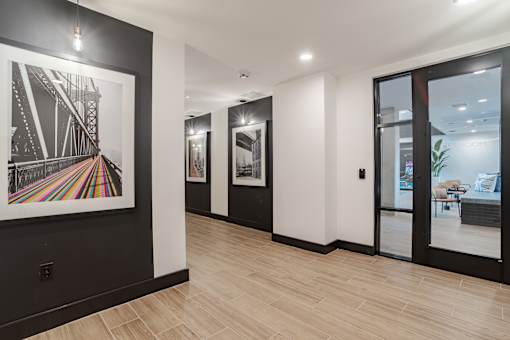 Contemporary hallway with framed bridge artwork and pendant lighting at The Yancey Apartments, Charlotte, 28217