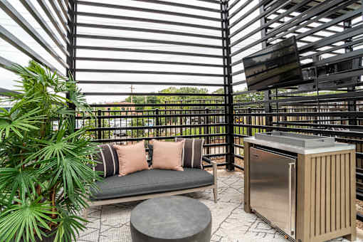 Covered patio with outdoor kitchen and lounge seating at The Yancey Apartments, Charlotte, North Carolina
