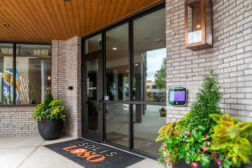 Building entrance with keypad access and welcome mat at The Yancey Apartments, Charlotte, NC