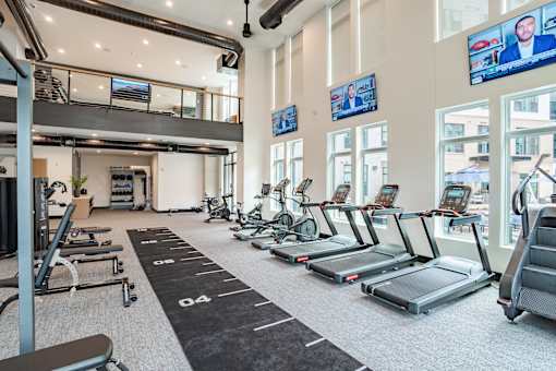 Spacious fitness center with treadmills and stationary bikes at The Yancey Apartments, Charlotte