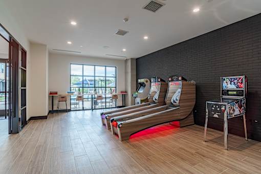 Game room with skee ball and arcade machine at The Yancey Apartments, North Carolina