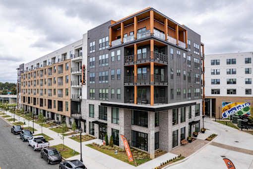 Modern apartment complex with orange accent framing and balconies at The Yancey Apartments, Charlotte, North Carolina