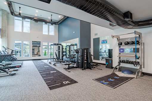 Fitness center with cardio machines and functional training area at The Yancey Apartments, Charlotte, NC 28217