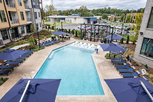 Outdoor pool with tanning ledge and cabana seating at The Yancey Apartments, North Carolina, 28217