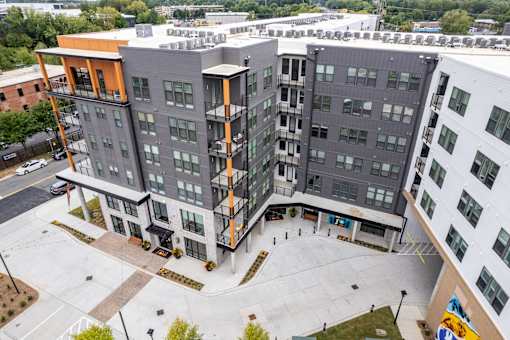 Aerial view of modern apartment courtyard with gray facade at The Yancey Apartments, Charlotte, NC 28217