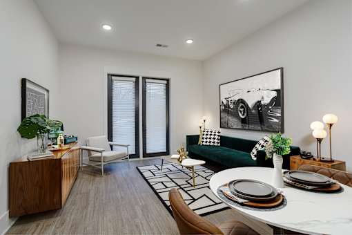 A modern living room with a green couch and a coffee table at Vintage Edge Nashville Apartments, Tennessee