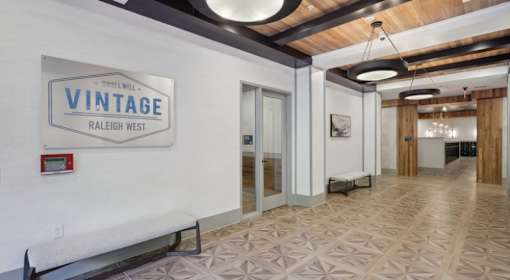 A sign that says Vintage Raleigh West is on a wall at Vintage Raleigh West Apartments, Raleigh, NC