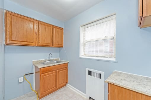 a kitchen with wood cabinets and a sink