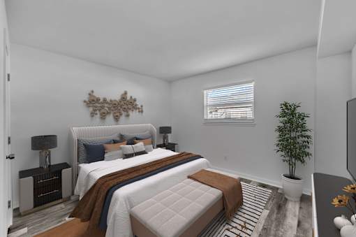 A bedroom with a large bed and a decorative wall piece.