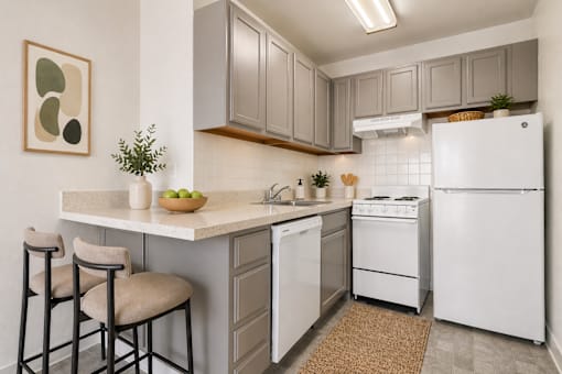 A kitchen with white appliances and a white refrigerator.