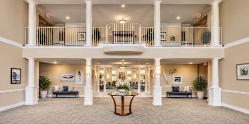 A large, open-concept living space with a balcony and a central seating area.