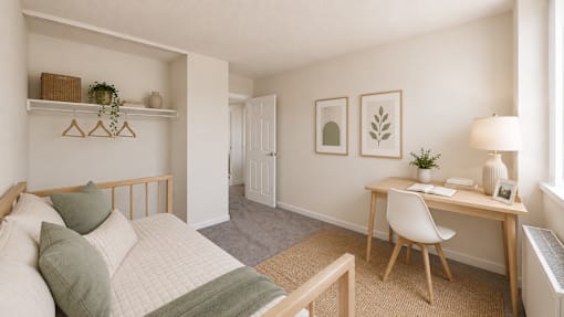 A bedroom with a bed, desk, and chair.