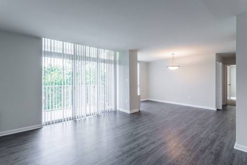 A room with a large window and wooden flooring at Charlestowne North Apartments, Maryland