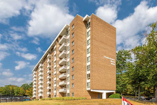 A tall brick building with the words at Charlestowne North Apartments, Greenbelt, MD, 20770