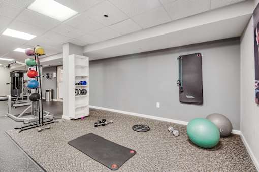 Gym room with variety of equipment, weight rack and exercise balls at Columbia Pointe, Columbia, MD, Maryland 