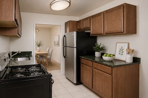 A kitchen with a black stove and a black refrigerator.