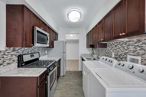 Kitchen With White Cabinetry And Appliances at Columbia Pointe, Columbia