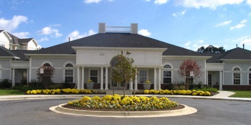a large white house with yellow flowers in front of it at Overland Gardens, Landover, MD 