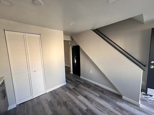 A room with a staircase leading to the upper floor at Pleasantview Apartments, Baltimore, MD, 21214