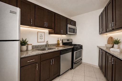 A kitchen with brown cabinets and a white refrigerator.