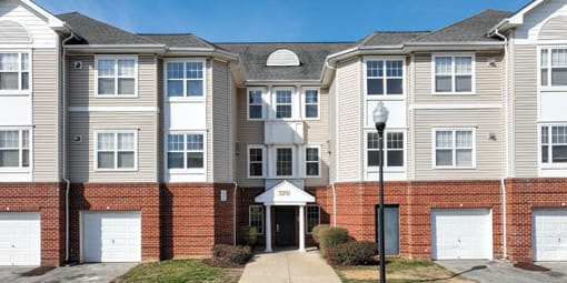 a row of town houses with a sidewalk in front of them at Overland Gardens, Landover 