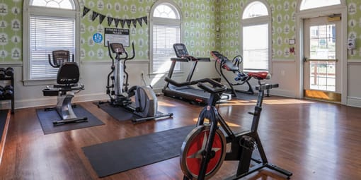 a gym with exercise equipment in a large room at Overland Gardens, Landover, MD 20785 
