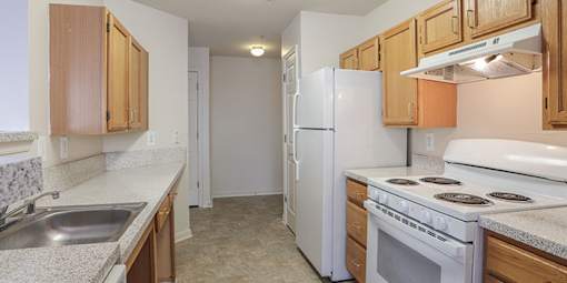 a kitchen with a stove refrigerator and sink at Overland Gardens, Maryland 