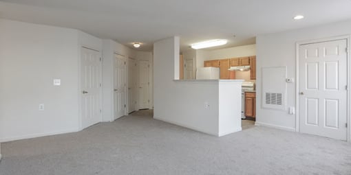 an empty living room and a kitchen with a counter at Overland Gardens, Landover, MD 20785 