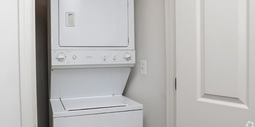 a white washer and dryer in a white room at Overland Gardens, Landover, 20785 