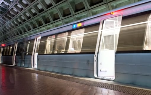 A subway train is passing through a subway station at Argent Apartments, Silver Spring, 20910