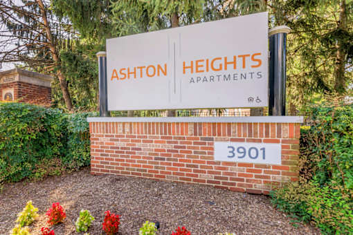 A sign for Ashton Heights Apartments is displayed in front of a brick wall at Ashton Heights Apartments, Suitland, Maryland