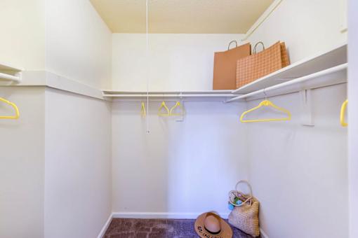 A small closet with a hat and a bag on the floor at Ashton Heights Apartments, Suitland, Maryland