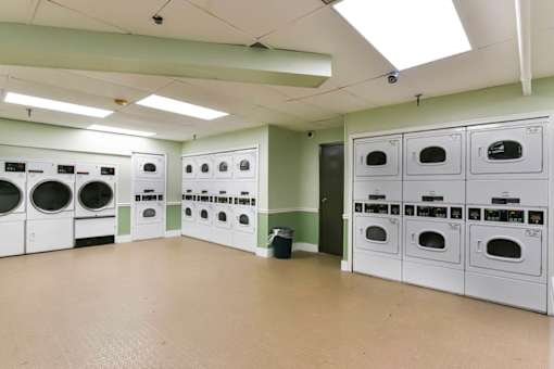 A laundry room with washing machines and dryers at Ashton Heights Apartments, Suitland, MD, 20746