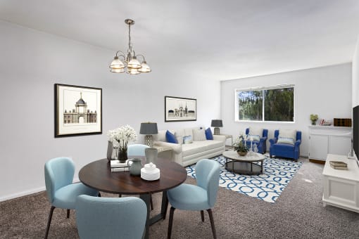 living room at Creekside at Tasker's Chance in Frederick, MD with dining area with four chairs, couch, chairs, coffee table, cabinet storage and area rug