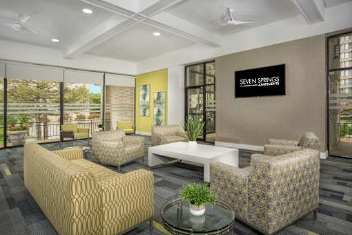 A waiting area with a sign that says "Seven Springs Apartments".