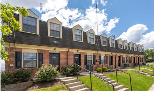 A row of houses with black shutters and red doors at Dutch Village Apartments, Baltimore, 21234
