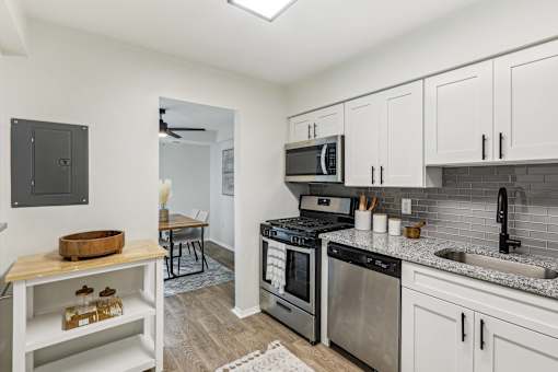 Modern kitchen with stainless steel appliances and white cabinets at Columbia Pointe, Columbia, Maryland 