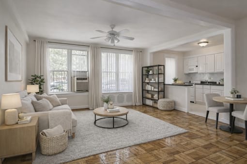 A living room with a white couch, a coffee table, and a ceiling fan.
