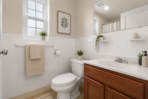 Bathroom with subway tile and wood vanity cabinet at University Landing Apartments, Maryland, 20903