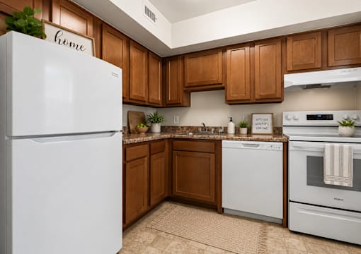 Lshaped kitchen with granite counters and white appliances at University Landing Apartments, Silver Spring, MD