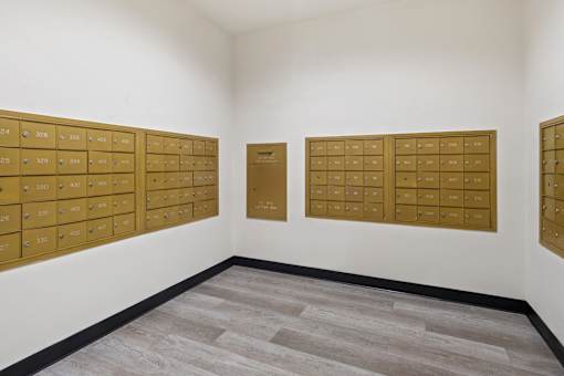 A room with a white wall and a grey floor with a brown board on the wall.