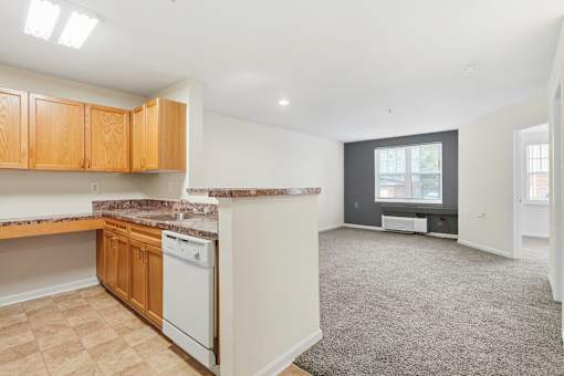 A kitchen with wooden cabinets and a white dishwasher.