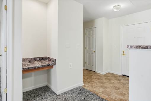 A room with a marble countertop and a tiled floor.
